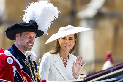 Prinz William und Prinzessin Kate sitzen in einer Kutsche. Beide lächeln, Kate winkt in Richtung der Kamera.