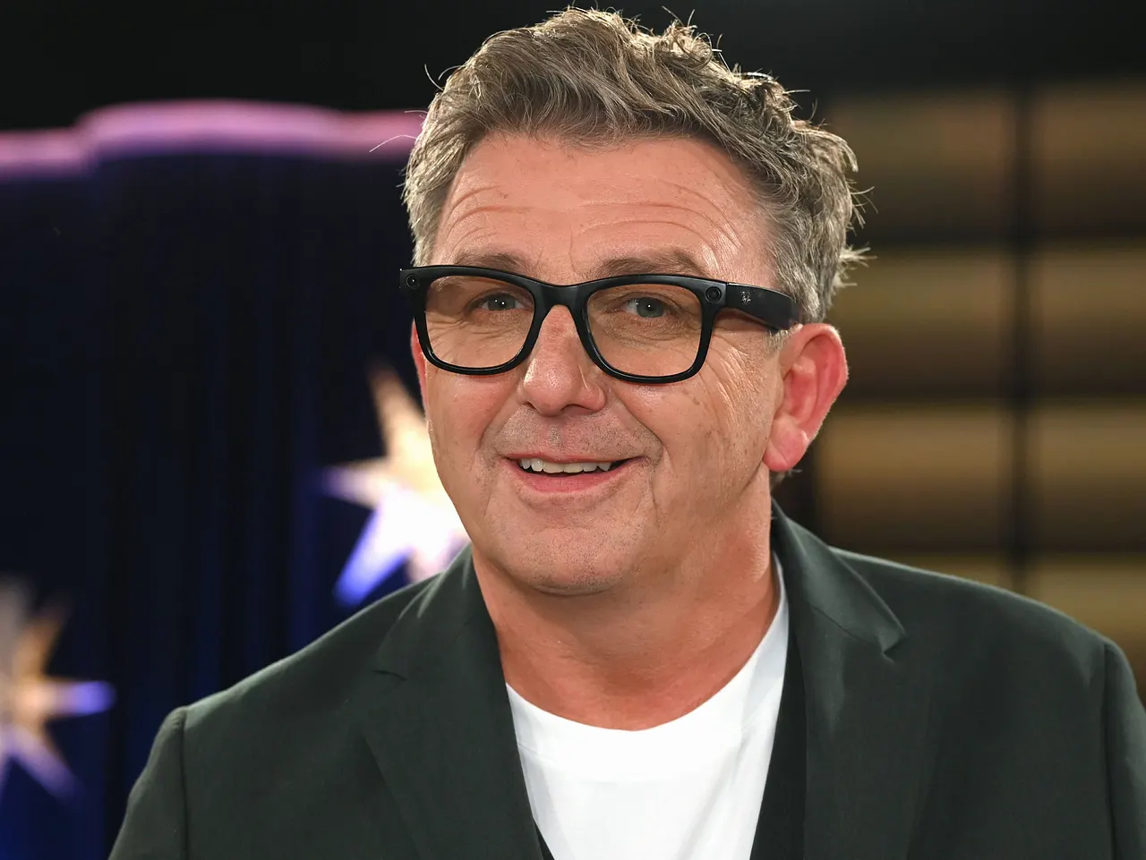 Hans Sigl blickt direkt in die Kamera und lächelt mit leicht geöffnetem Mund. - Foto: IMAGO / Horst Galuschka Hans Sigl blickt direkt in die Kamera und lächelt mit leicht geöffnetem Mund.