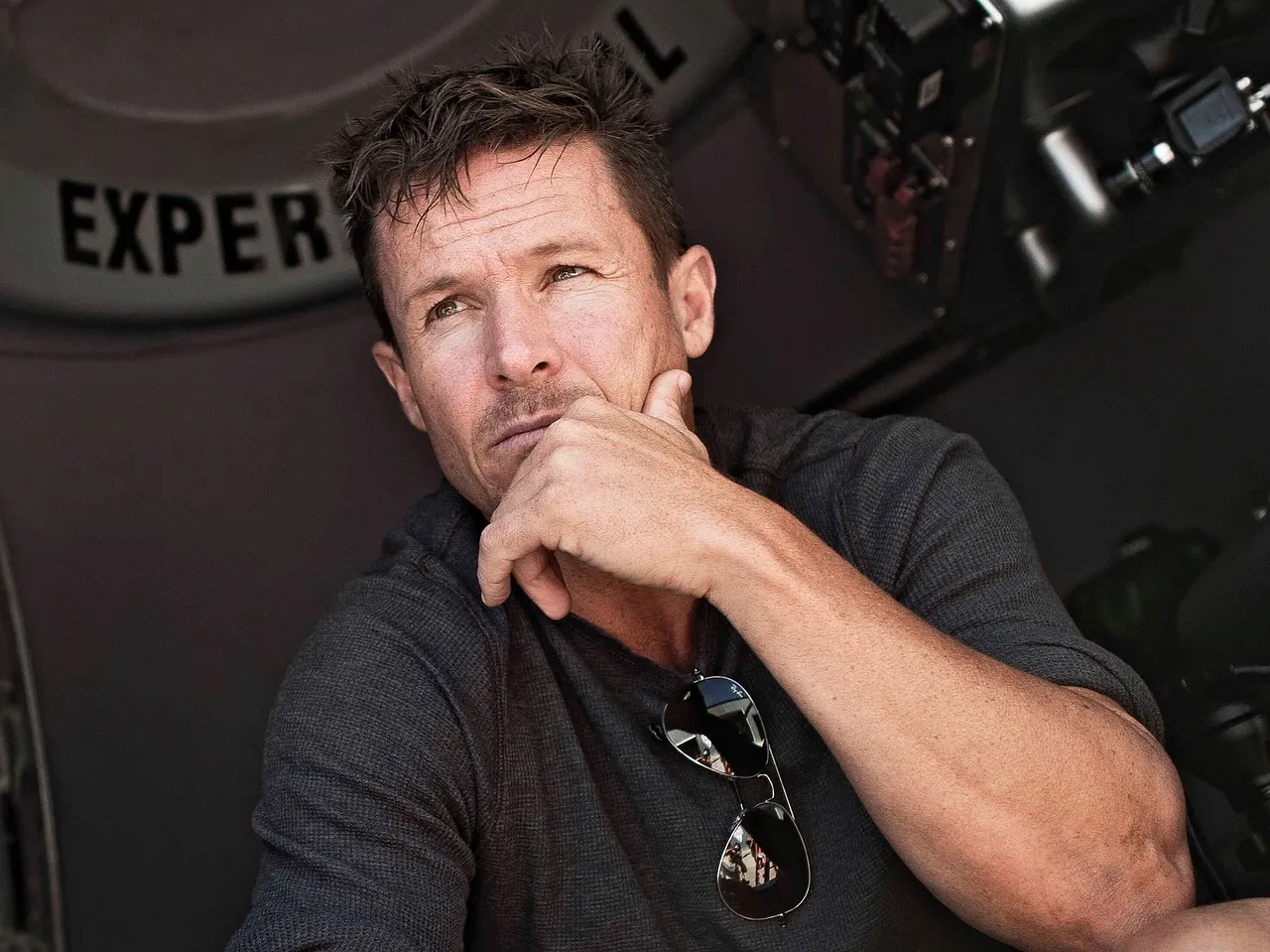 imago826190895 Felix Baumgartner kniet mit ernstem Gesicht und einer Hand am Kinn in seiner Kapsel. - Foto: IMAGO / Avalon.red