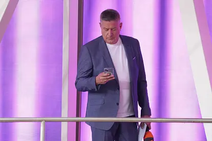 Joachim Llambi blickt ernst auf sein Handy.