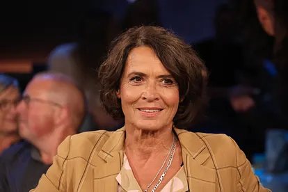 Ulrike Folkert hat ein Lächeln auf den Lippen und blickt leicht zur Seite.